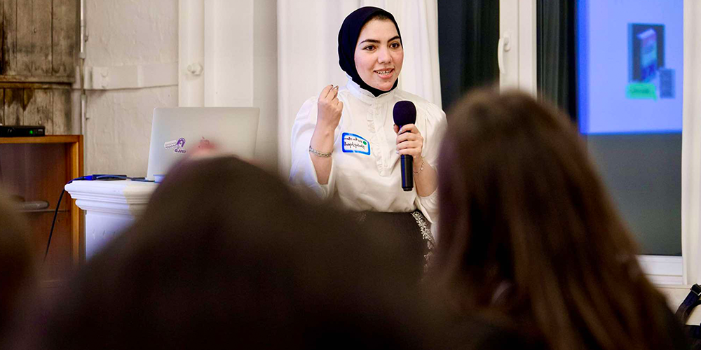 A woman lecturing an audience